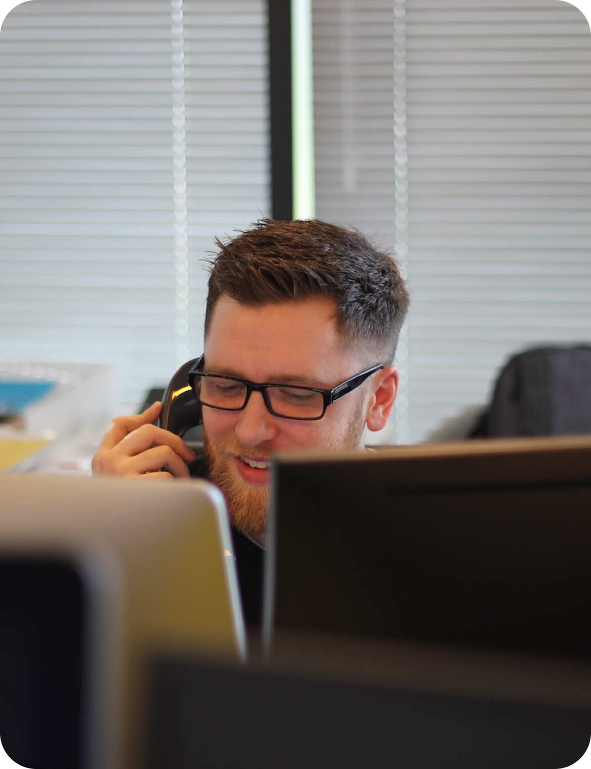 Condeo administrator on the phone at his workstation