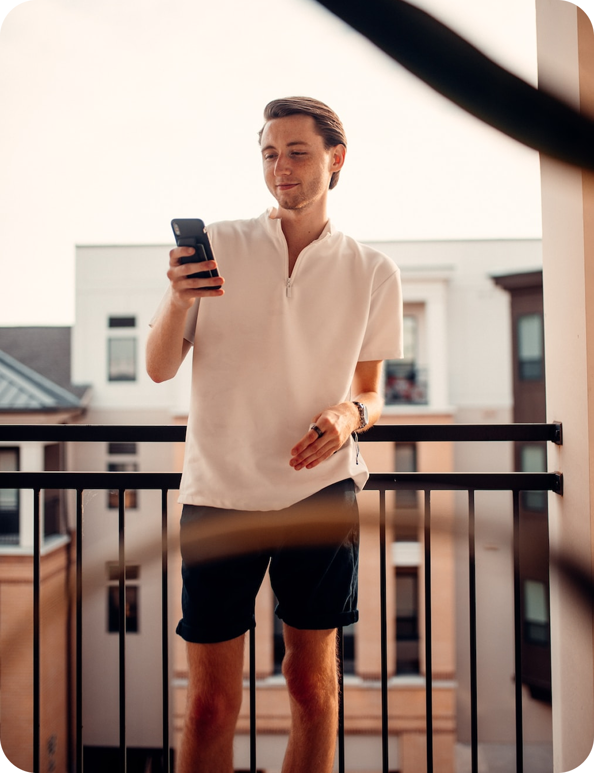 Resident on a Milan balcony checking condominium updates on the Condeo app