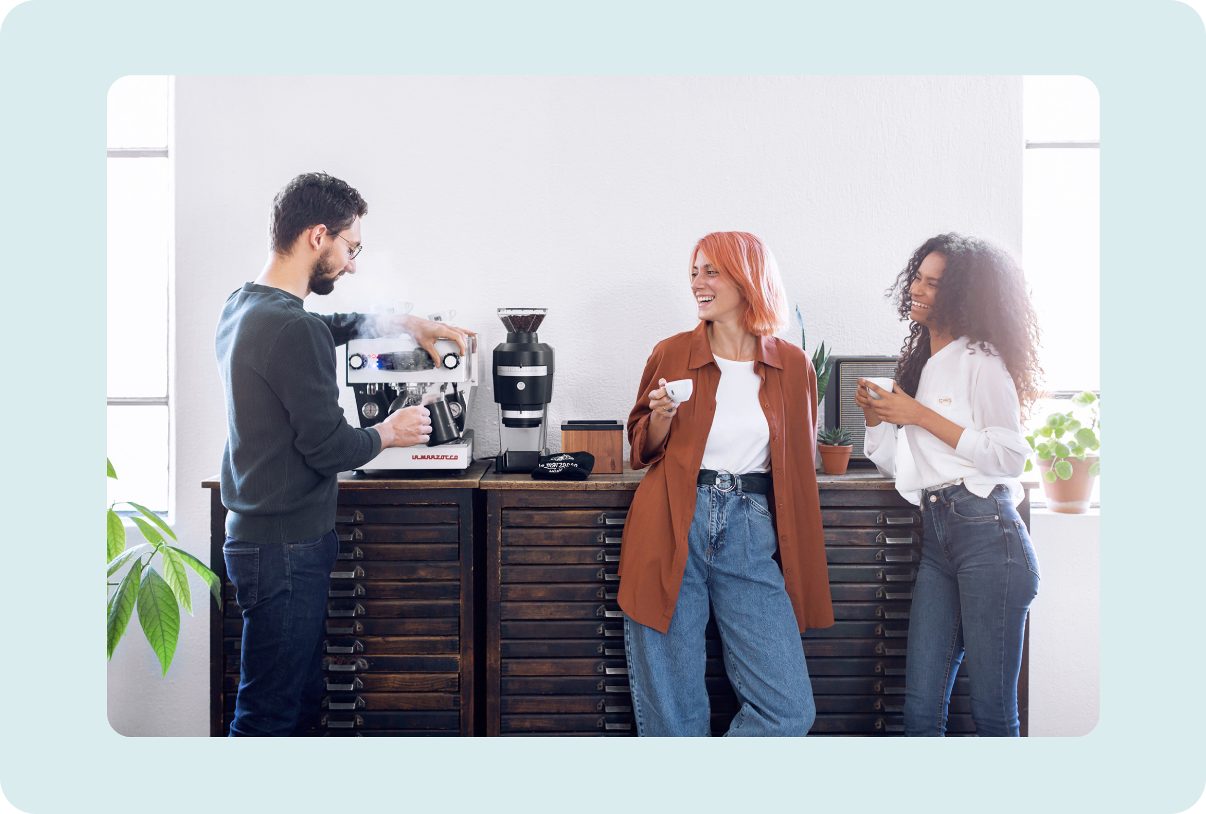La Marzocco team collaborating around an espresso machine