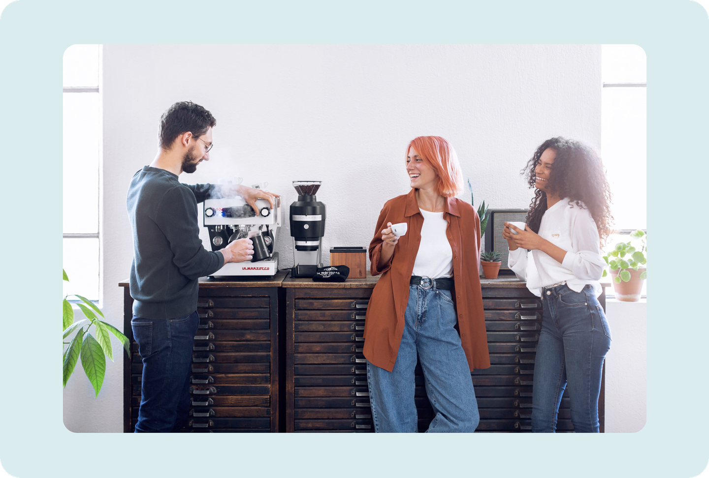 La Marzocco team collaborating around an espresso machine