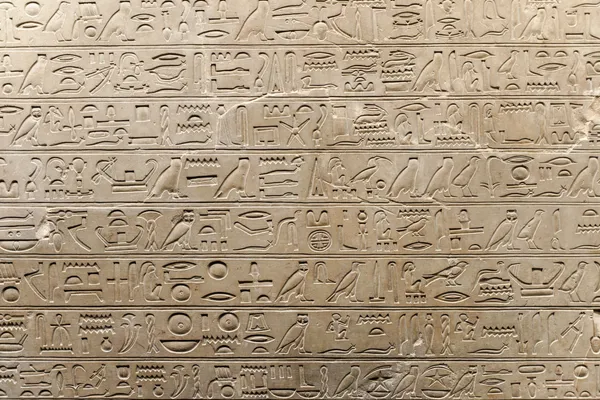 Egyptian hieroglyphs carved on a temple wall
