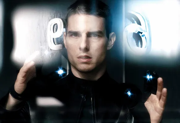 Tom Cruise in Minority Report using a gesture interface, manipulating floating data screens