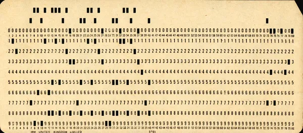 Close-up of an IBM 80-column punch card with holes punched in rows